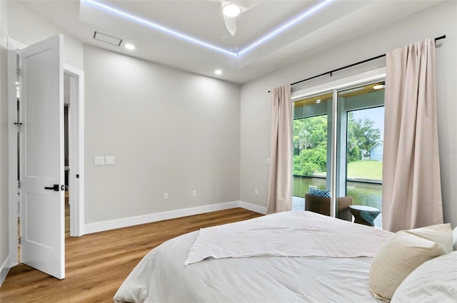 56 Columbia Ln, Palm Coast, FL 32137 - bedroom featuring access to exterior, wood finished floors, and recessed lighting