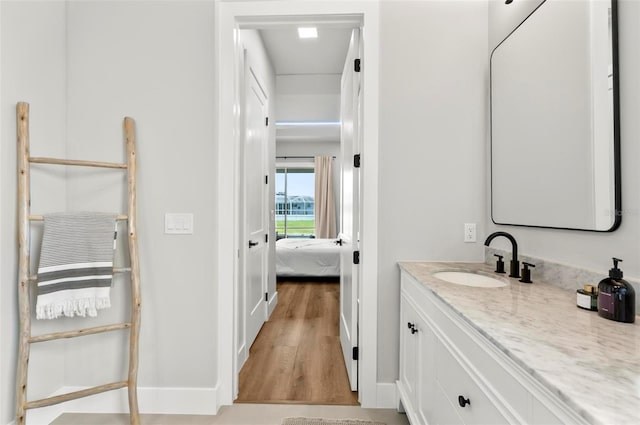 56 Columbia Ln, Palm Coast, FL 32137 - bathroom featuring vanity, wood finished floors, and ensuite bathroom