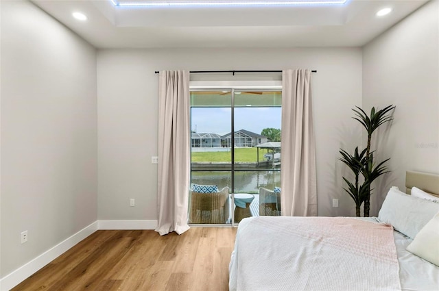 56 Columbia Ln, Palm Coast, FL 32137 - bedroom featuring access to exterior, wood finished floors, and recessed lighting