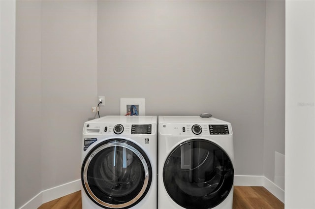 56 Columbia Ln, Palm Coast, FL 32137 - laundry room with washing machine and clothes dryer and wood finished floors