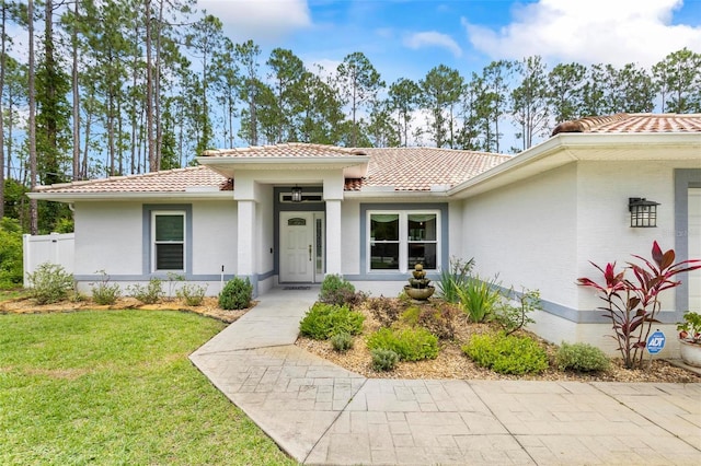 82 Ryland Dr, Palm Coast, FL 32164 - view of front facade featuring a tile roof and a front yard