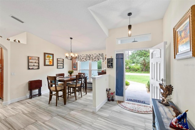 82 Ryland Dr, Palm Coast, FL 32164 - foyer featuring a chandelier, arched walkways, baseboards, vaulted ceiling, and a textured ceiling