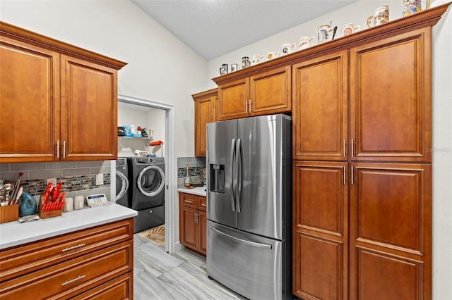 82 Ryland Dr, Palm Coast, FL 32164 - kitchen with stainless steel refrigerator with ice dispenser, washing machine and clothes dryer, decorative backsplash, and light countertops