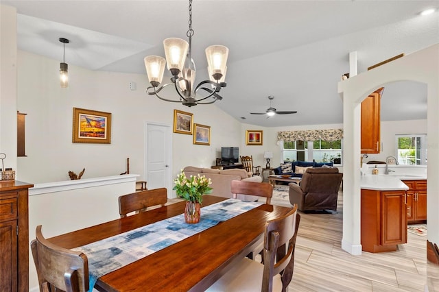 82 Ryland Dr, Palm Coast, FL 32164 - dining area featuring vaulted ceiling, a chandelier, arched walkways, and a ceiling fan