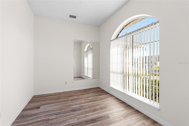 16 Flemington Ln, Palm Coast, FL 32137 - empty room with plenty of natural light, wood finished floors, and baseboards