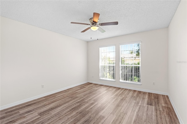 16 Flemington Ln, Palm Coast, FL 32137 - spare room featuring wood finished floors, a textured ceiling, baseboards, and ceiling fan
