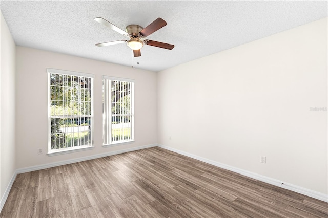 16 Flemington Ln, Palm Coast, FL 32137 - empty room with wood finished floors, a ceiling fan, baseboards, and a textured ceiling