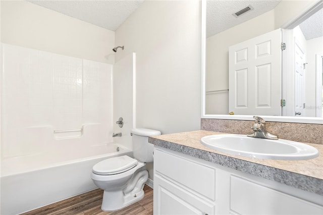 16 Flemington Ln, Palm Coast, FL 32137 - full bath featuring a textured ceiling, toilet, vanity, wood finished floors, and  shower combination