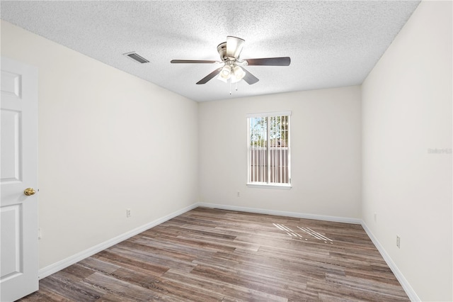 16 Flemington Ln, Palm Coast, FL 32137 - empty room with ceiling fan, wood finished floors, a textured ceiling, and baseboards