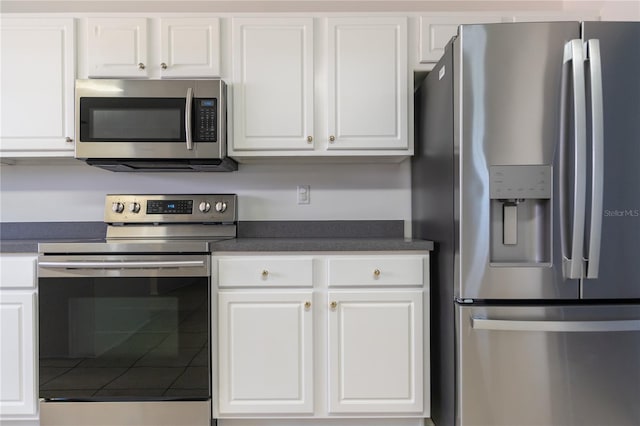 16 Flemington Ln, Palm Coast, FL 32137 - kitchen with appliances with stainless steel finishes, dark countertops, and white cabinetry