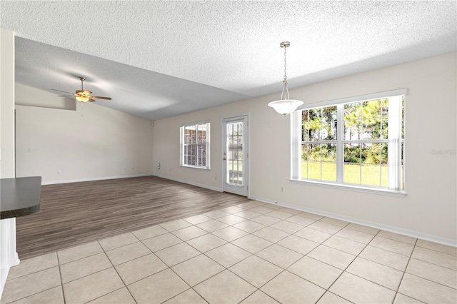 16 Flemington Ln, Palm Coast, FL 32137 - unfurnished room featuring a textured ceiling, ceiling fan, light wood finished floors, and baseboards