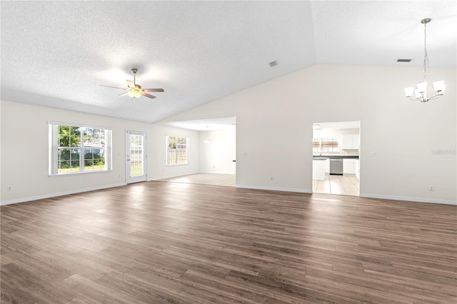 16 Flemington Ln, Palm Coast, FL 32137 - unfurnished living room featuring a chandelier, a ceiling fan, vaulted ceiling, wood finished floors, and a textured ceiling