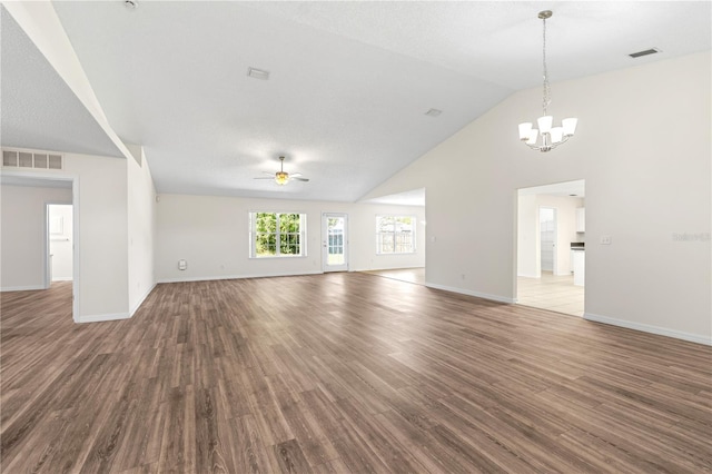 16 Flemington Ln, Palm Coast, FL 32137 - unfurnished living room with a ceiling fan, wood finished floors, a chandelier, baseboards, and high vaulted ceiling