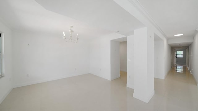 1 John Anderson Dr Unit 2180, Ormond Beach, FL 32176 - empty room with a chandelier, baseboards, light tile patterned floors, and ornamental molding