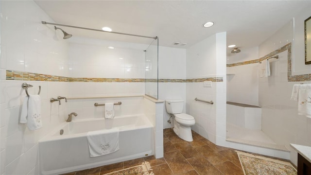 1 John Anderson Dr Unit 2180, Ormond Beach, FL 32176 - bathroom featuring tile walls, toilet, a bath, tiled shower, and recessed lighting