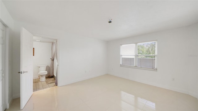 1 John Anderson Dr Unit 2180, Ormond Beach, FL 32176 - unfurnished bedroom featuring light tile patterned floors and connected bathroom