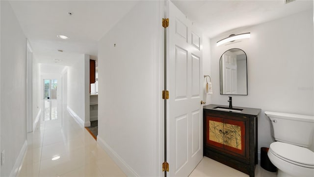 1 John Anderson Dr Unit 2180, Ormond Beach, FL 32176 - hallway featuring a sink, tile patterned floors, baseboards, and recessed lighting