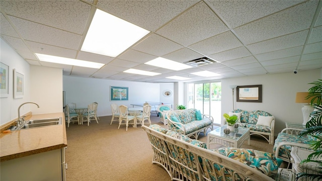 1 John Anderson Dr Unit 2180, Ormond Beach, FL 32176 - living room featuring light colored carpet and a paneled ceiling