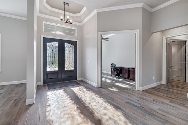 514 Wingspan Dr, Ormond Beach, FL 32174 - entryway with french doors, wood finished floors, baseboards, crown molding, and a chandelier