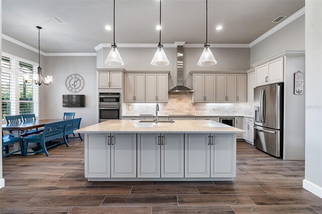 514 Wingspan Dr, Ormond Beach, FL 32174 - kitchen with appliances with stainless steel finishes, wall chimney exhaust hood, a sink, crown molding, and a center island with sink