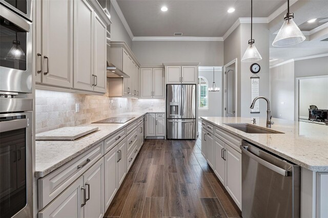 514 Wingspan Dr, Ormond Beach, FL 32174 - kitchen with appliances with stainless steel finishes, a sink, crown molding, tasteful backsplash, and light stone countertops