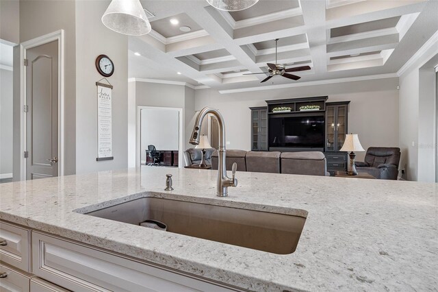 514 Wingspan Dr, Ormond Beach, FL 32174 - kitchen featuring a sink, coffered ceiling, a ceiling fan, light stone counters, and crown molding