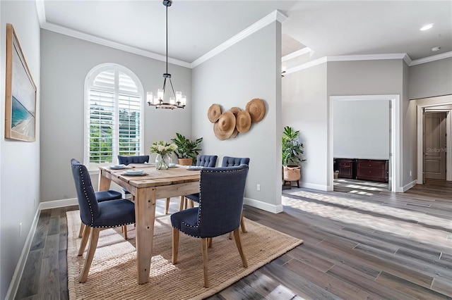 514 Wingspan Dr, Ormond Beach, FL 32174 - dining space featuring a chandelier, baseboards, wood finished floors, and crown molding