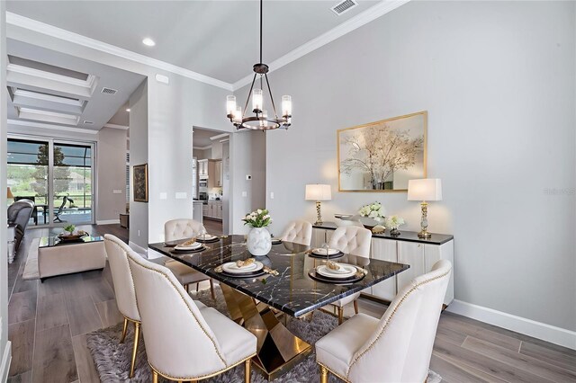 514 Wingspan Dr, Ormond Beach, FL 32174 - dining space with wood finished floors, baseboards, a chandelier, crown molding, and recessed lighting