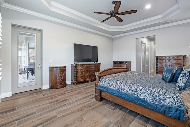 514 Wingspan Dr, Ormond Beach, FL 32174 - bedroom featuring a raised ceiling, crown molding, wood tiled floors, baseboards, and a ceiling fan