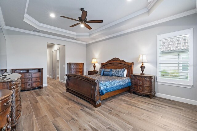514 Wingspan Dr, Ormond Beach, FL 32174 - bedroom with a tray ceiling, light wood finished floors, baseboards, crown molding, and recessed lighting