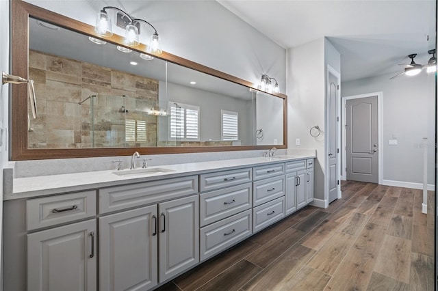 514 Wingspan Dr, Ormond Beach, FL 32174 - full bathroom with double vanity, a stall shower, wood finished floors, and ceiling fan