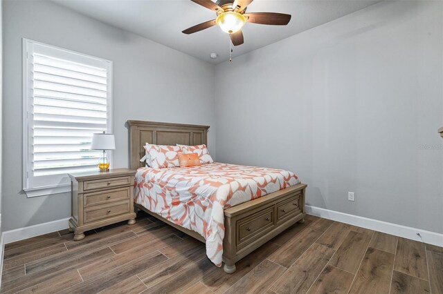 514 Wingspan Dr, Ormond Beach, FL 32174 - bedroom with dark wood-style floors, baseboards, and ceiling fan