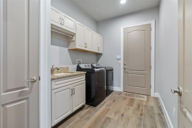 514 Wingspan Dr, Ormond Beach, FL 32174 - laundry area with independent washer and dryer, cabinet space, light wood-type flooring, baseboards, and recessed lighting