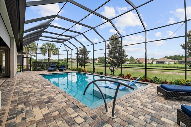 514 Wingspan Dr, Ormond Beach, FL 32174 - swimming pool featuring a hot tub, a patio, and glass enclosure