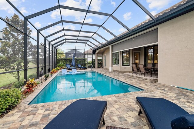 514 Wingspan Dr, Ormond Beach, FL 32174 - outdoor pool with a patio area and glass enclosure