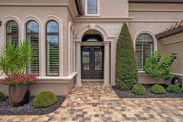 514 Wingspan Dr, Ormond Beach, FL 32174 - property entrance featuring french doors and stucco siding