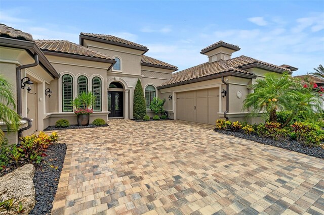 514 Wingspan Dr, Ormond Beach, FL 32174 - mediterranean / spanish home with an attached garage, driveway, stucco siding, and a tiled roof