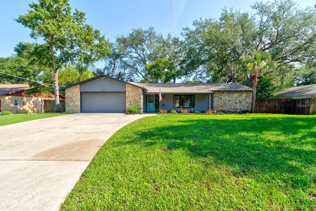 35 Whippoorwill Ln, Ormond Beach, FL 32174 - mid-century home featuring stone siding, driveway, an attached garage, and stucco siding