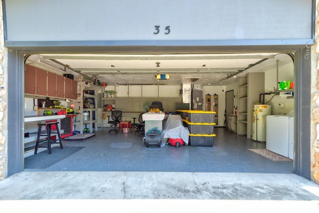 35 Whippoorwill Ln, Ormond Beach, FL 32174 - garage featuring water heater, washer and clothes dryer, and a garage door opener