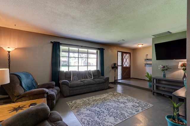 35 Whippoorwill Ln, Ormond Beach, FL 32174 - living room featuring a textured ceiling, finished concrete flooring, and baseboards