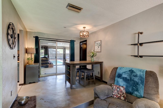 35 Whippoorwill Ln, Ormond Beach, FL 32174 - dining space featuring finished concrete flooring, a chandelier, a textured ceiling, and baseboards