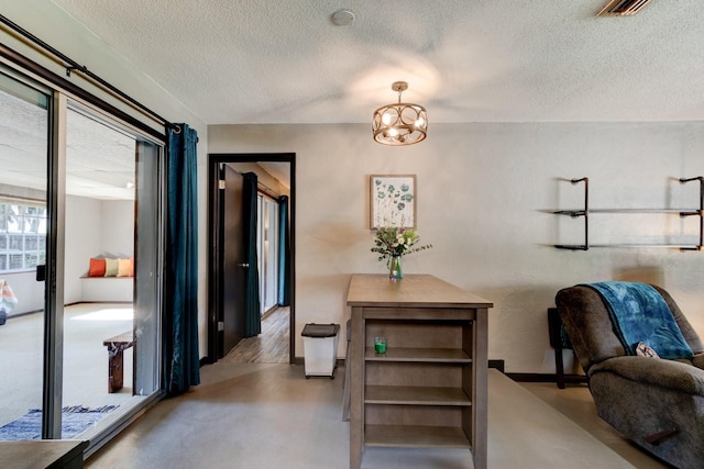35 Whippoorwill Ln, Ormond Beach, FL 32174 - dining space featuring a textured ceiling, a chandelier, concrete floors, and baseboards