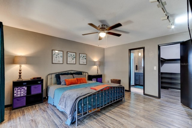 35 Whippoorwill Ln, Ormond Beach, FL 32174 - bedroom featuring rail lighting, wood finished floors, baseboards, and ensuite bathroom