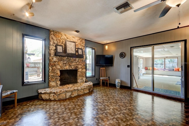 35 Whippoorwill Ln, Ormond Beach, FL 32174 - living room with baseboards, healthy amount of natural light, a textured ceiling, and wooden walls