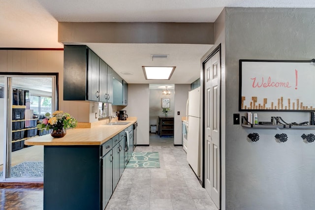 35 Whippoorwill Ln, Ormond Beach, FL 32174 - kitchen featuring a sink, freestanding refrigerator, and butcher block counters