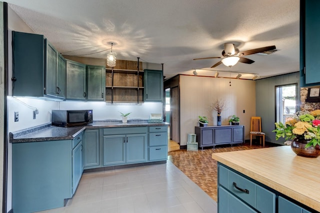 35 Whippoorwill Ln, Ormond Beach, FL 32174 - kitchen featuring black microwave, open shelves, ceiling fan, blue cabinets, and a textured ceiling