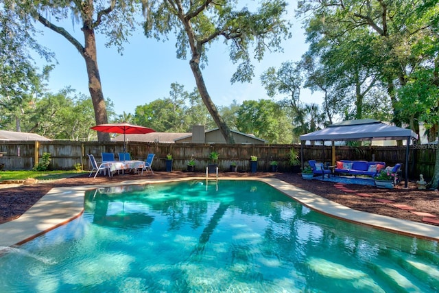 35 Whippoorwill Ln, Ormond Beach, FL 32174 - view of swimming pool featuring an outdoor living space, a fenced backyard, a gazebo, and a patio area