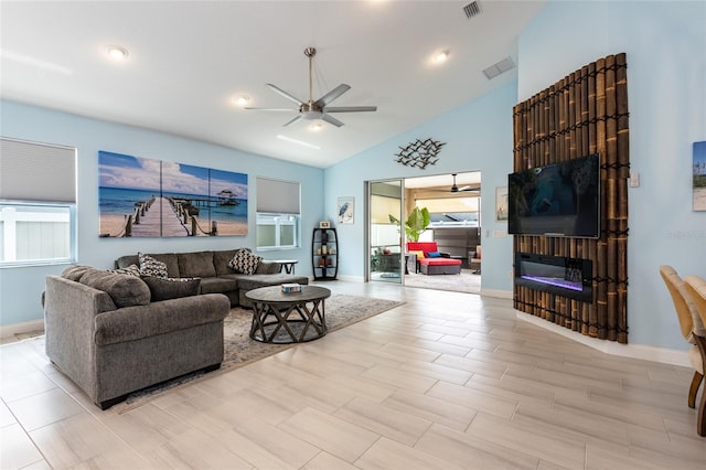 11 Tideway Trl, Palm Coast, FL 32137 - living room featuring ceiling fan, lofted ceiling, a glass covered fireplace, and baseboards