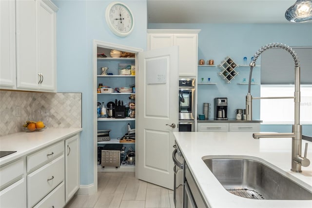 11 Tideway Trl, Palm Coast, FL 32137 - kitchen featuring a sink, white cabinetry, backsplash, and appliances with stainless steel finishes
