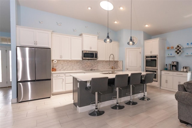 11 Tideway Trl, Palm Coast, FL 32137 - kitchen featuring appliances with stainless steel finishes, a sink, decorative backsplash, white cabinetry, and light countertops